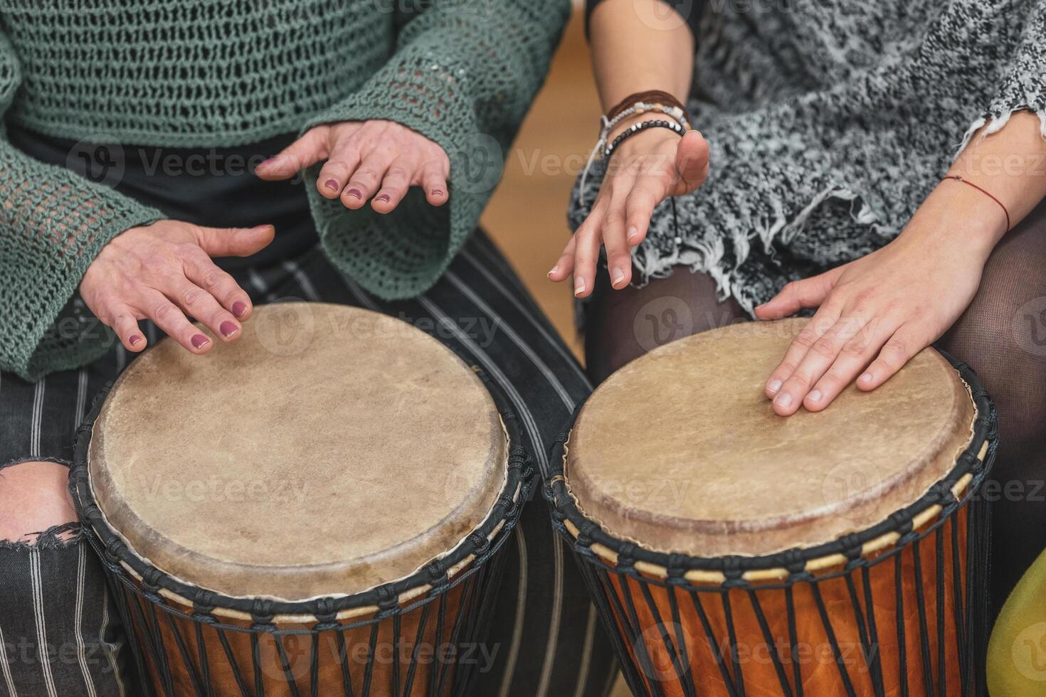 Group of people playing drums during a music therapy lessons, jembe drum, drumming concept photo