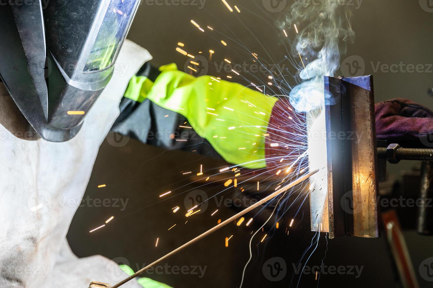Detail to welding process of metal parts, using a welding machine, bright sparks and flashes, industrial concept photo