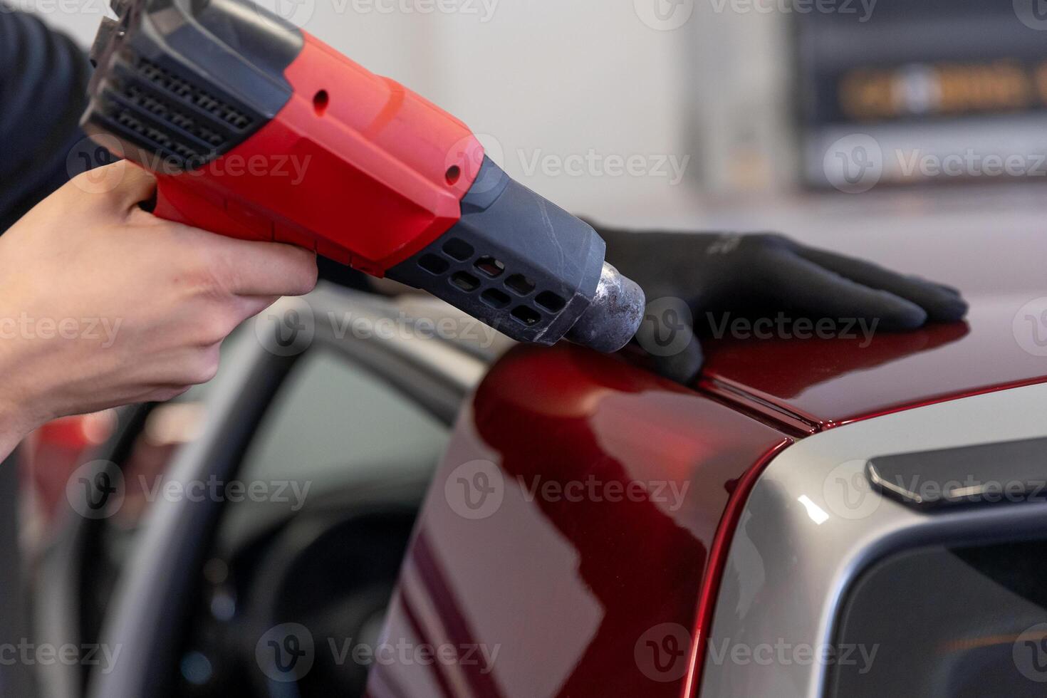 Wrapping a new foil to a car by heat gun, gluing a new foil, detailing concept photo