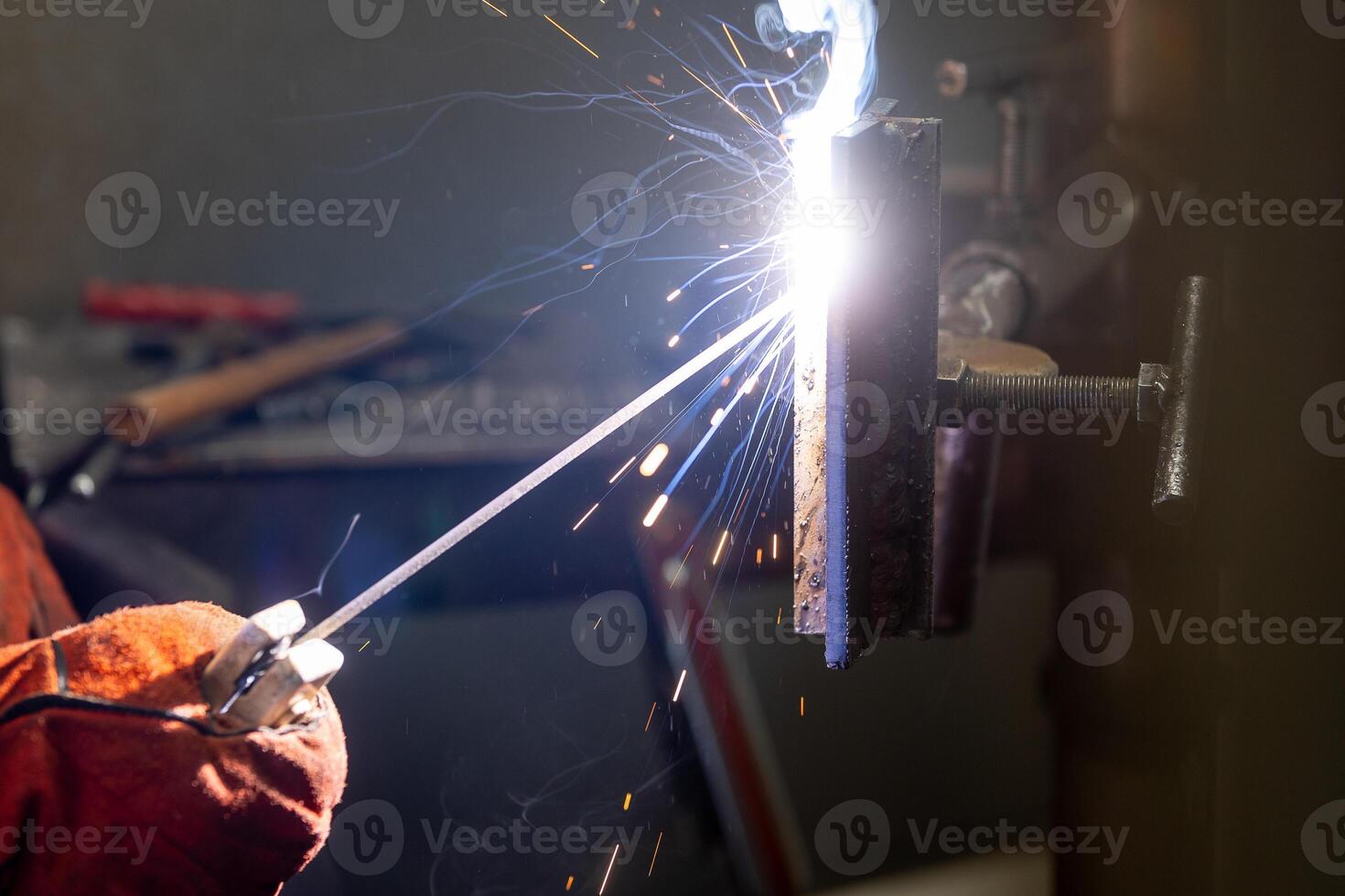Detail to welding process of metal parts, using a welding machine, bright sparks and flashes, industrial concept photo