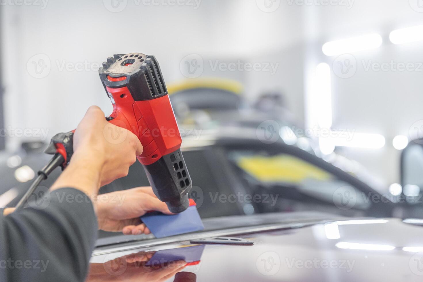 Wrapping a new foil to a car by heat gun, gluing a new foil, detailing concept photo