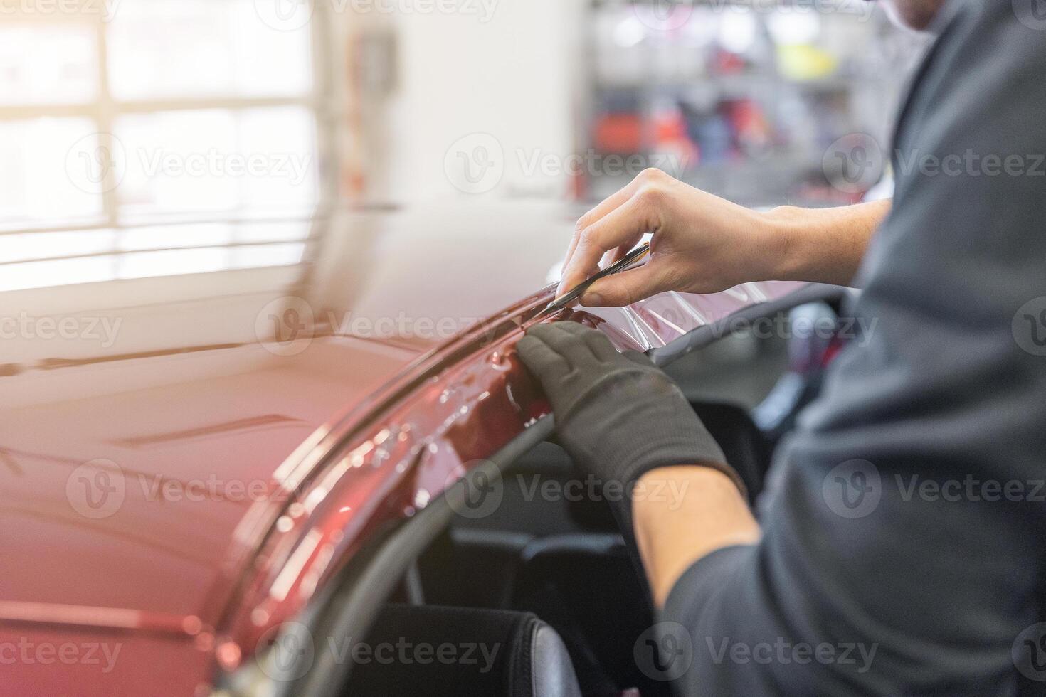 Process of gluing or wrapping a new foil wrap to a car, car detailing concept photo