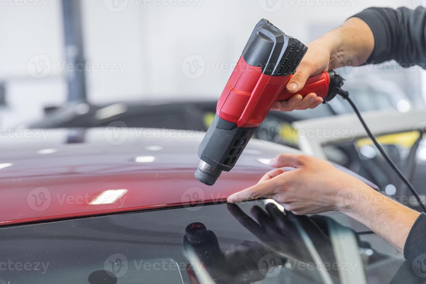 Wrapping a new foil to a car by heat gun, gluing a new foil, detailing concept photo