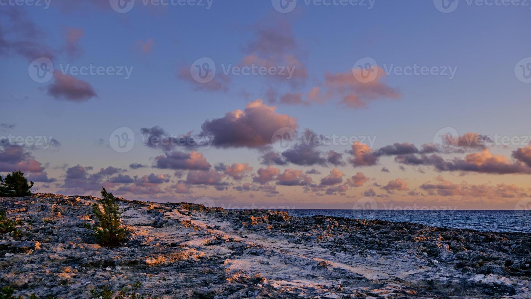 Small puffy clouds at sunrise over the Atlantic Ocean photo