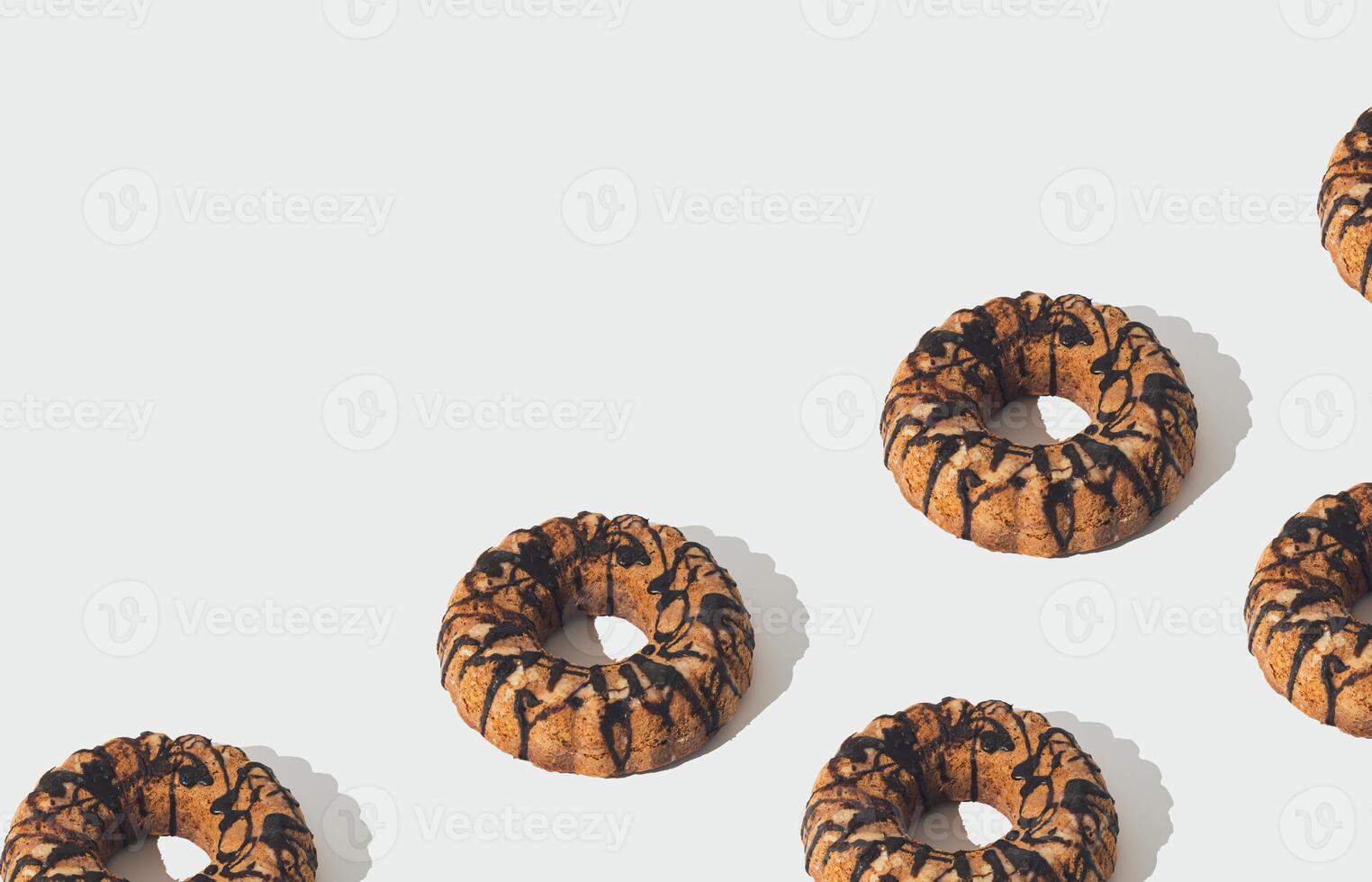 Creative trendy food pattern made of delicious cake with chocolate topping on white background with copy space. Minimal sweet dessert concept. Cake aesthetic. photo