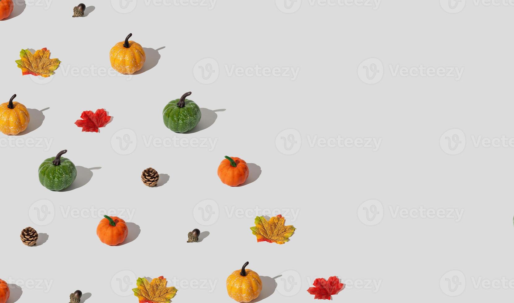Trendy autumn or fall pattern made with pumpkins, yellow and red fallen leaves, nuts and pinecones on white background. Minimal autumn objects composition. Nature flat lay. Season concept. Copy space. photo