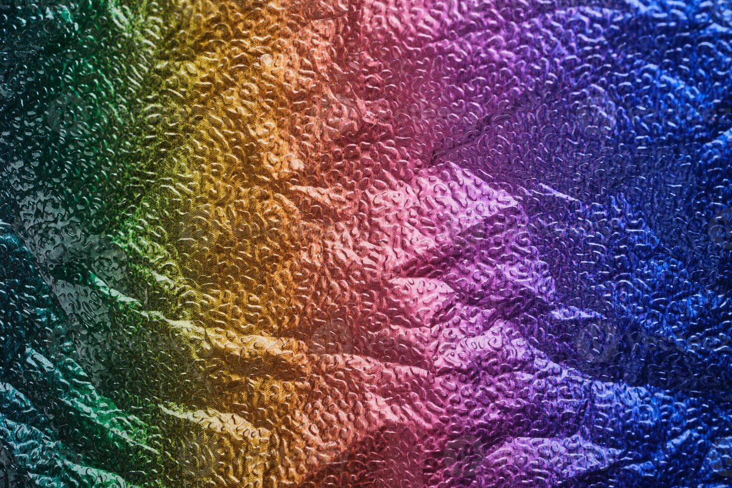 Rainbow gradient textural Background. Wrinkled folded paper or foil photo
