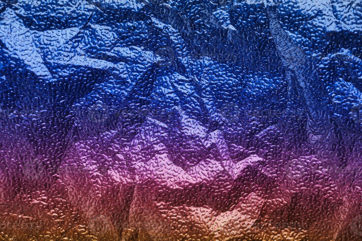 Rainbow gradient textural Background. Wrinkled folded paper or foil photo
