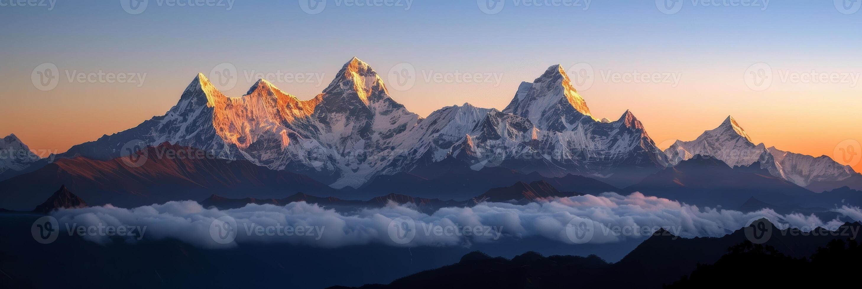 Sunset glow illuminates towering mountain peaks. photo