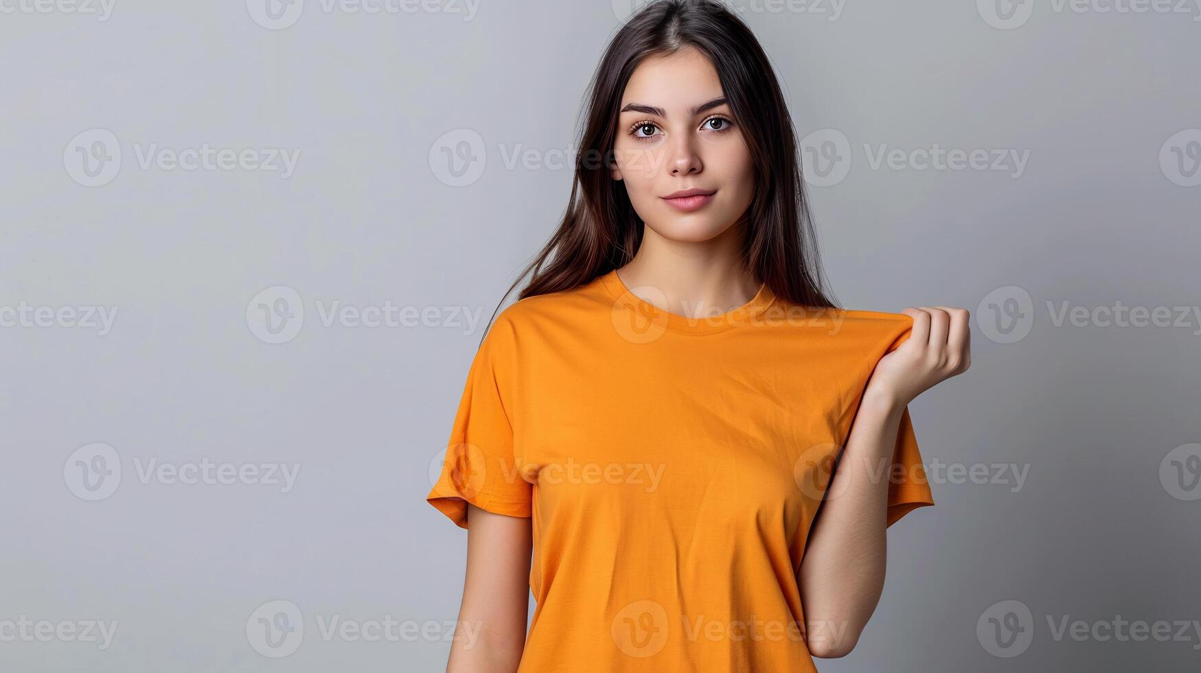 Photo portrait of lovely young lady hold look big empty space wear trendy t-shirt orange cotoon isolated on grey color background