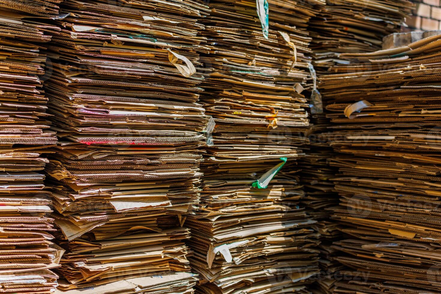 Stacks of crushed cardboard boxes, full-frame closeup background photo