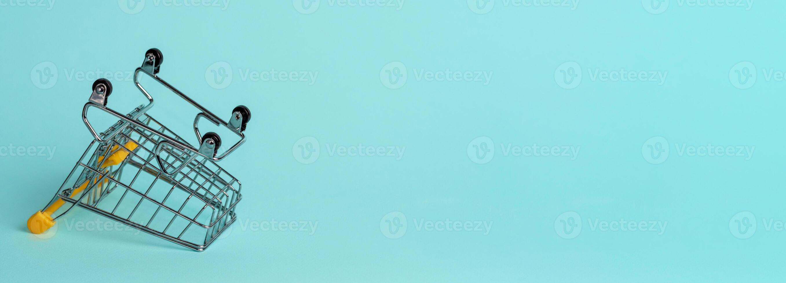 Empty inverted shopping cart, copy space photo