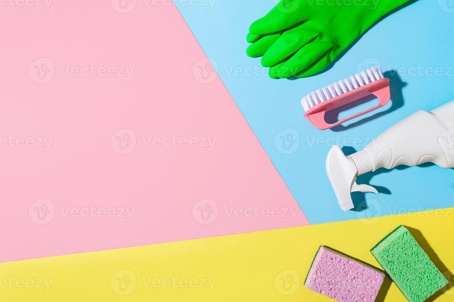 House cleaning product on pink background, copy space photo