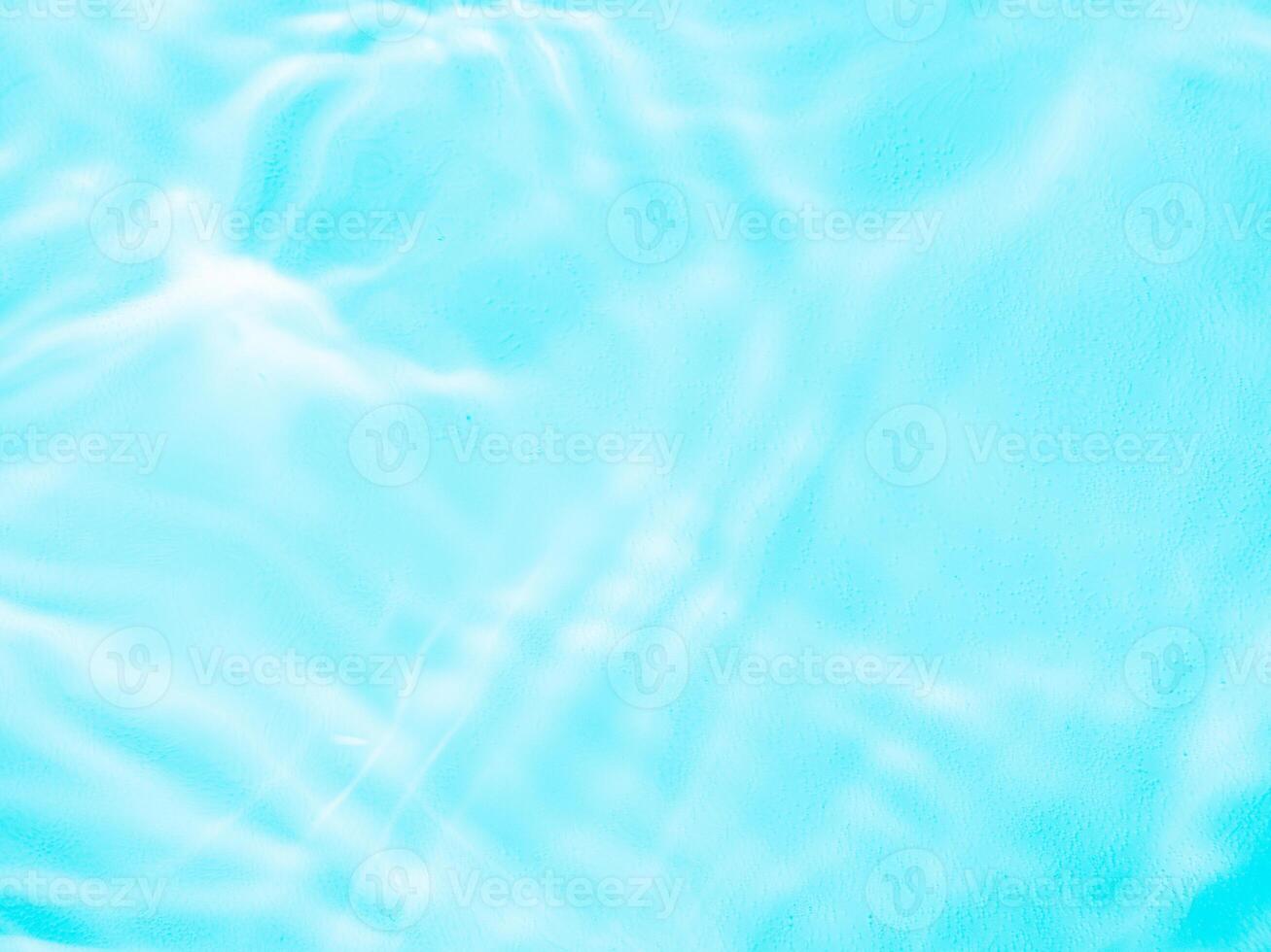 Ripple water texture with shadows on blue photo
