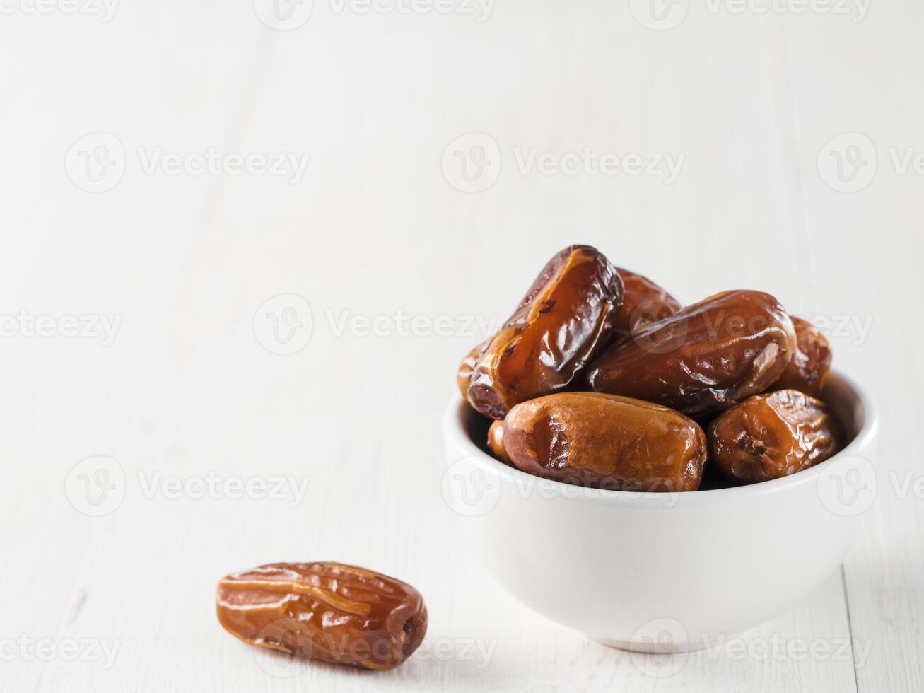 Plate of dried dates on table photo