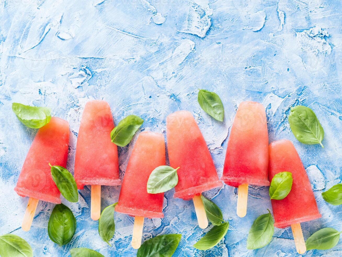 Top view of watermelon and basil popsicles with copy space photo