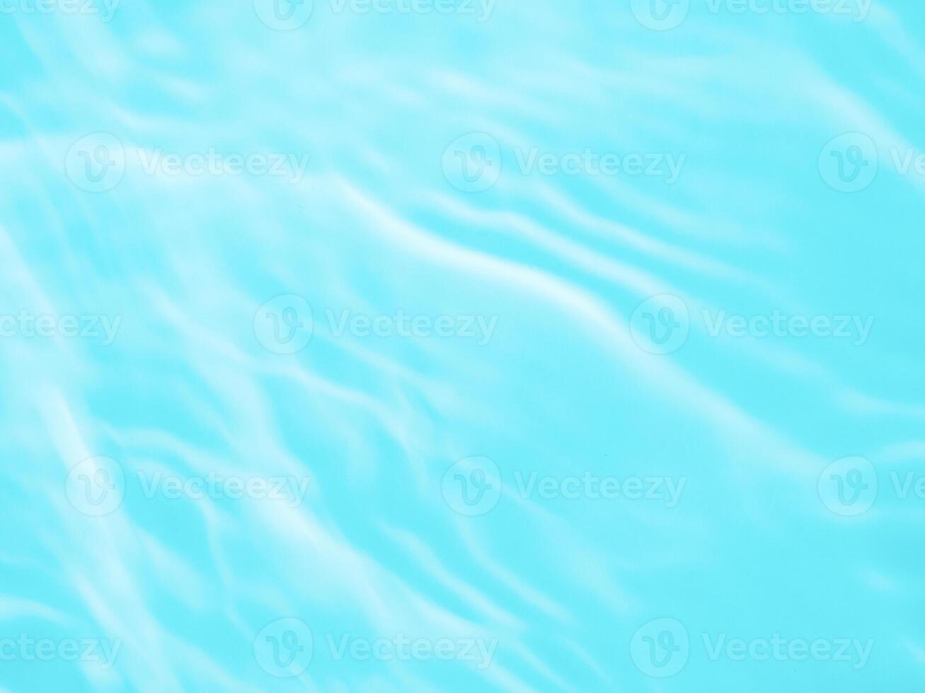 Ripple water texture with shadows on blue photo