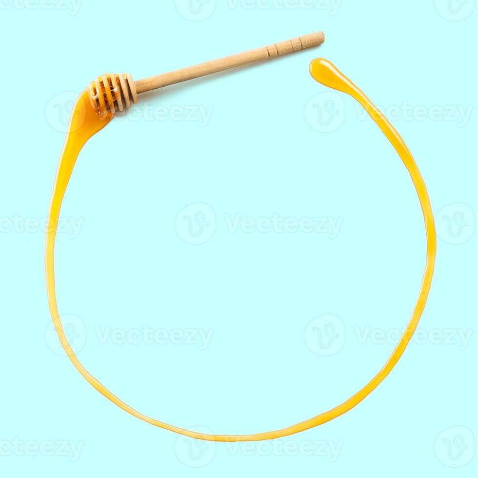 honey dipper with honey in circle form, copyspace photo