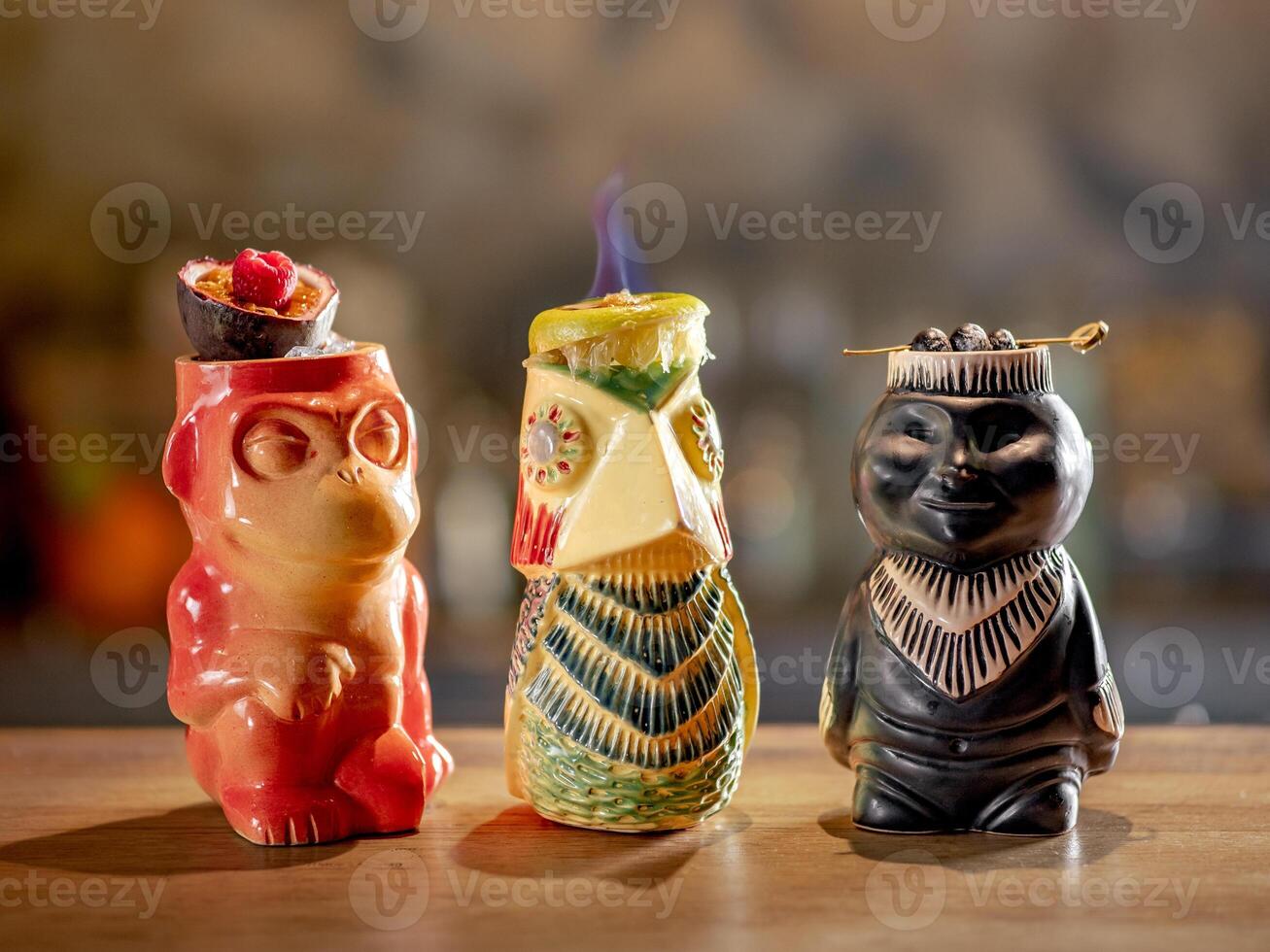 Set of three tropical tiki cocktail on bar counter photo