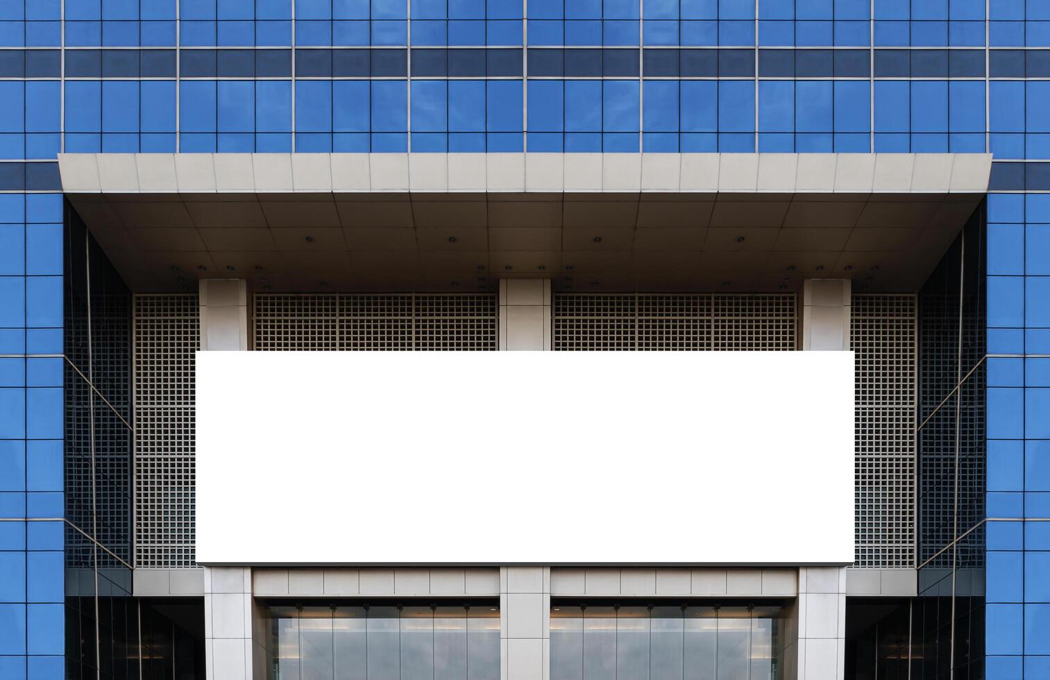 Mock up white horizontal large LED display billboard on entrance office building. Clipping path for mockup photo