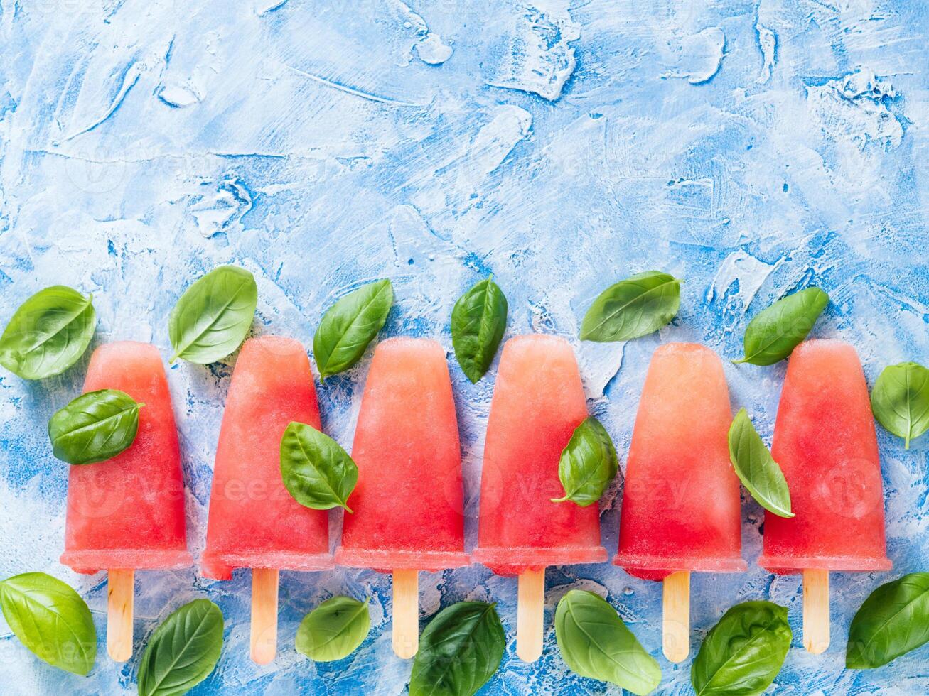 Top view of watermelon and basil popsicles with copy space photo