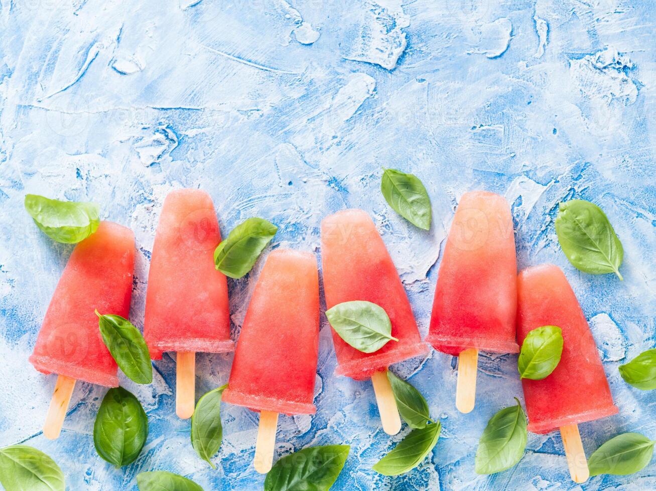Top view of watermelon and basil popsicles with copy space photo