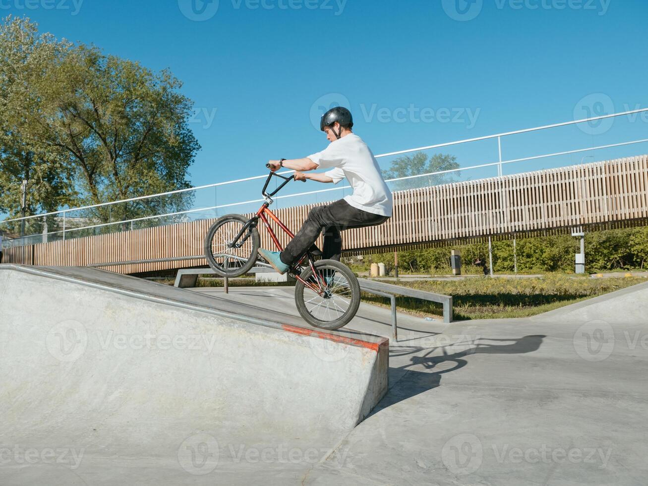 BMX bicycle rider performing Manual Wheelie trick photo