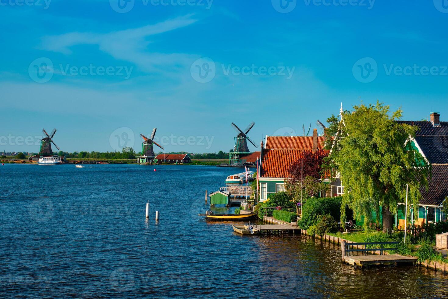 Windmills at Zaanse Schans in Holland on sunset. Zaandam, Netherlands photo