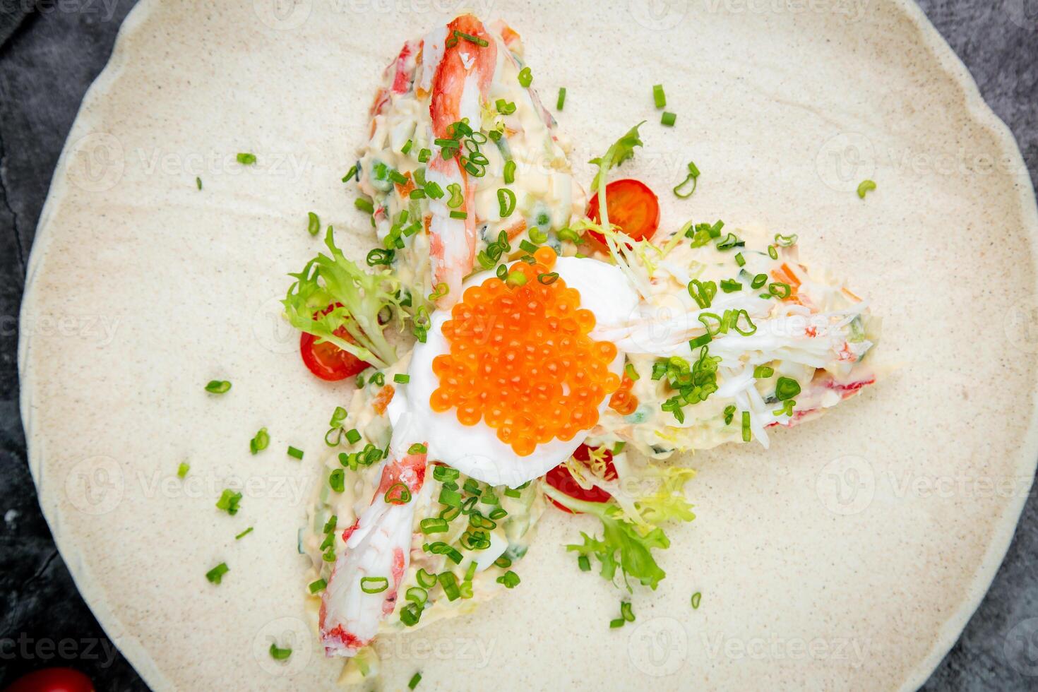 salad with mozzarella, caviar and green onions on a white plate, side view photo