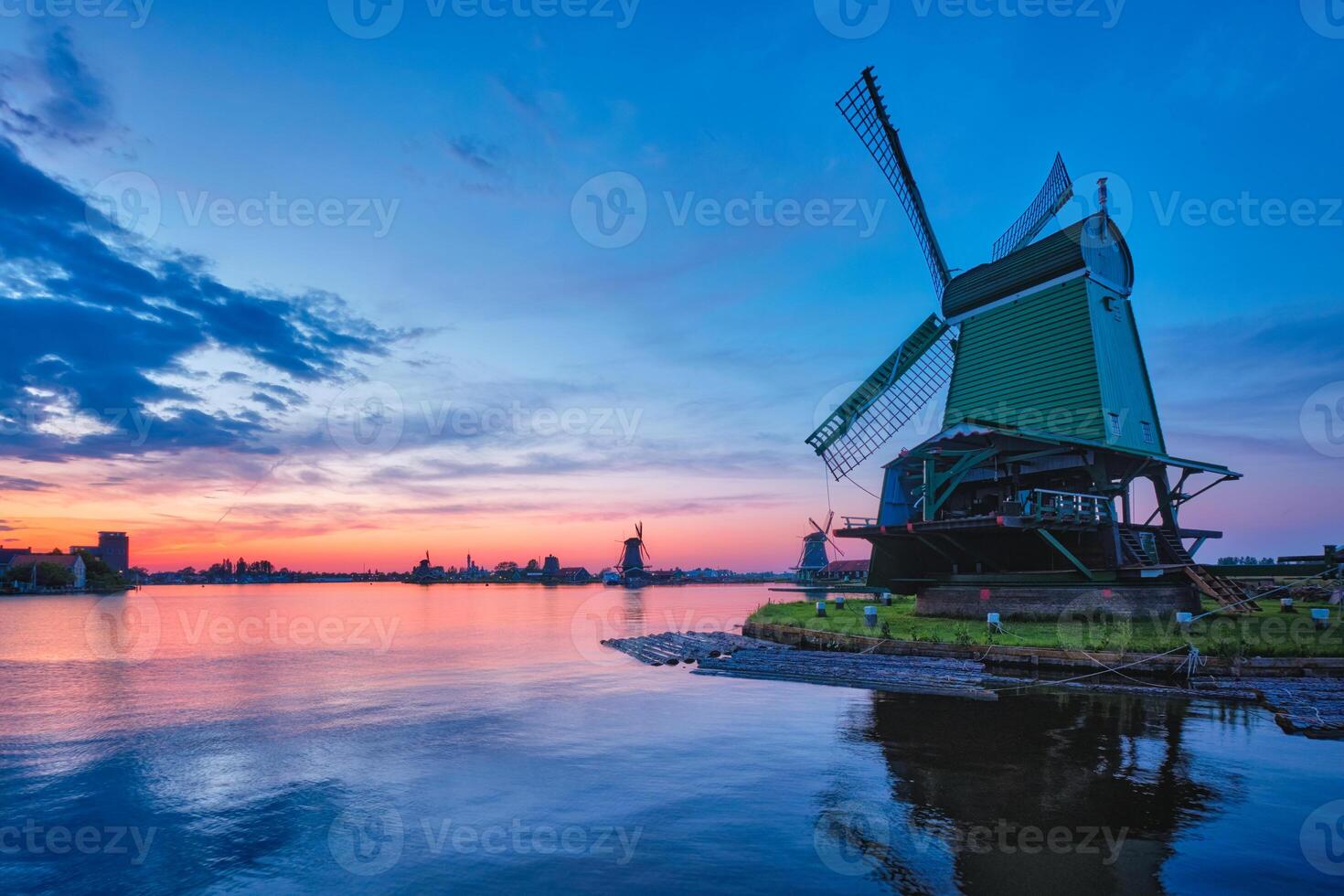 Windmills at famous tourist site Zaanse Schans in Holland with dramatic sky. Zaandam, Netherlands photo