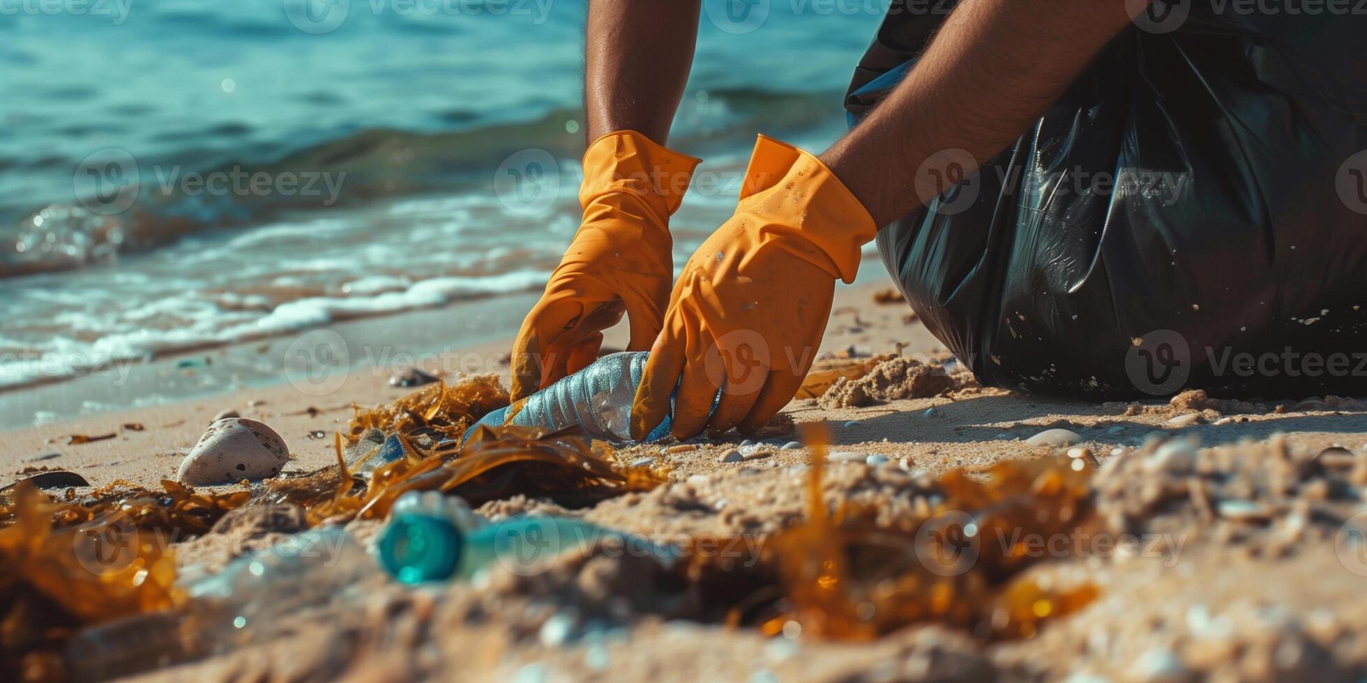 Hands picking up plastic trash on beach. Problem of environmental pollution by plastic and its recycling. photo