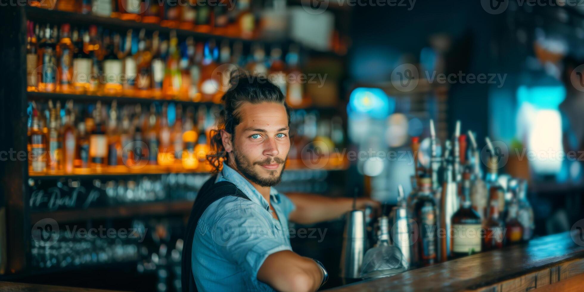 Handsome bartender standing at bar counter. photo