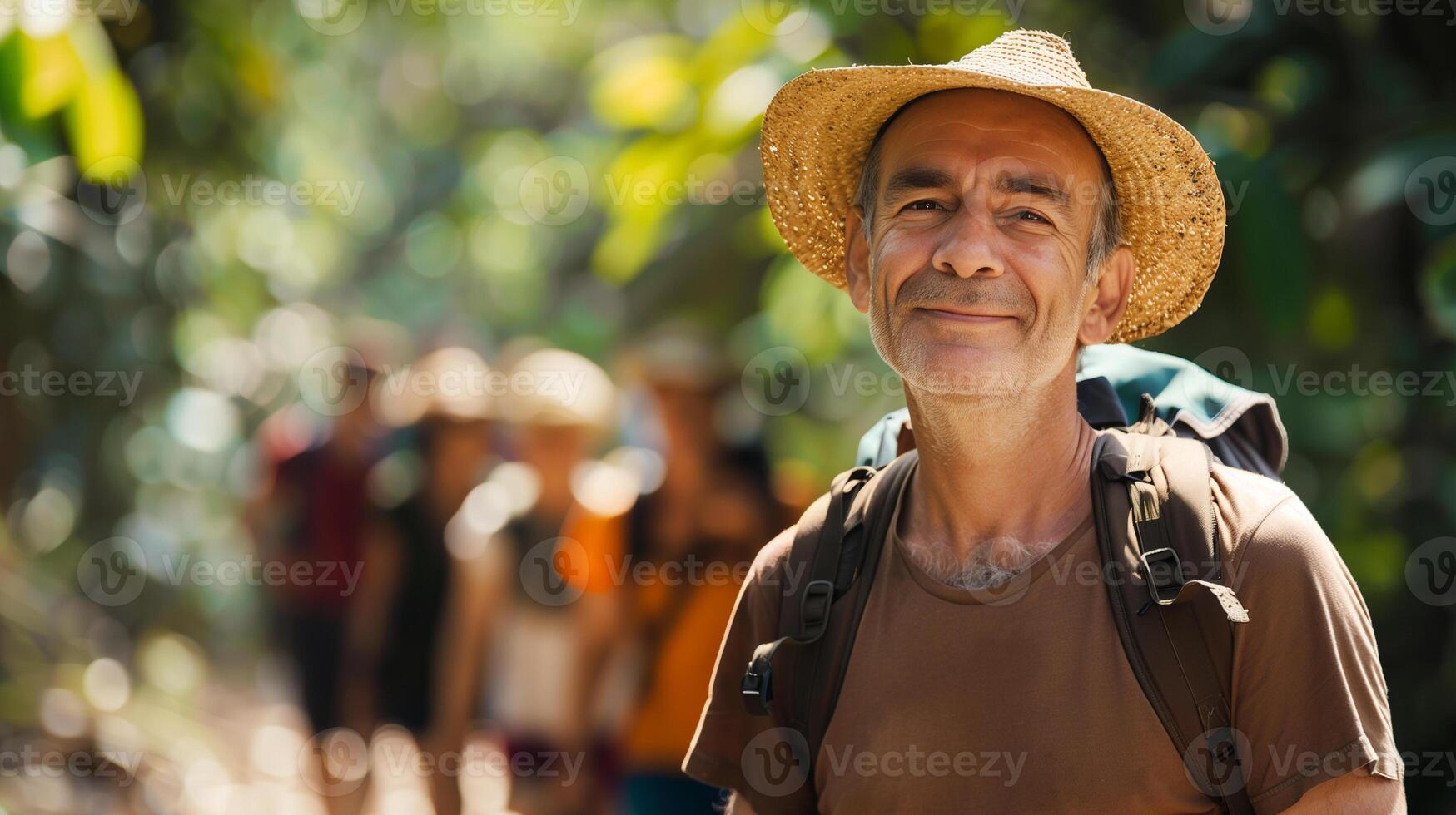 Tourists on excursions. Portrait of mature man walking through rainforest with tour group. Copy space. photo