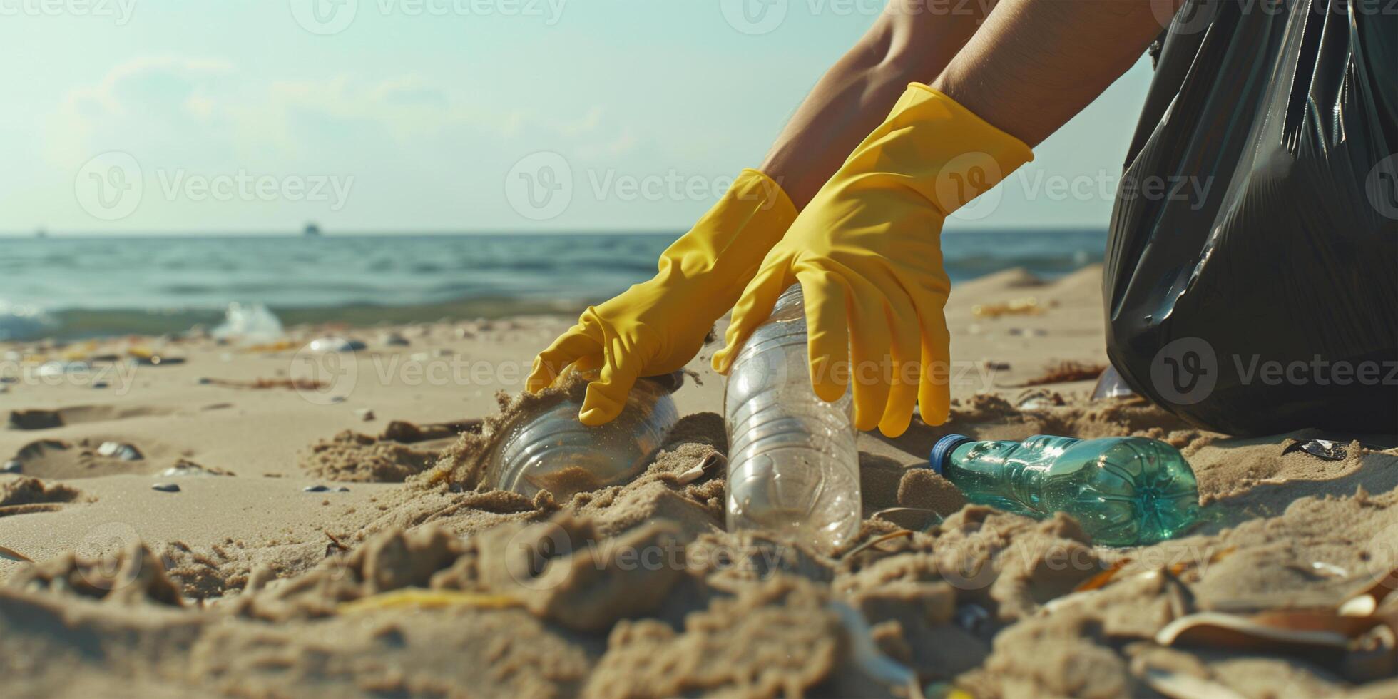Volunteer picking up plastic bottles on beach. Problem of environmental pollution by trash and its recycling. photo