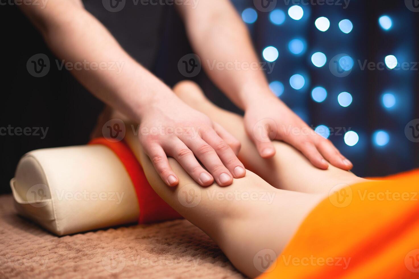 Massage stroking the ankle muscles in a professional office in a shallow depth of field. photo