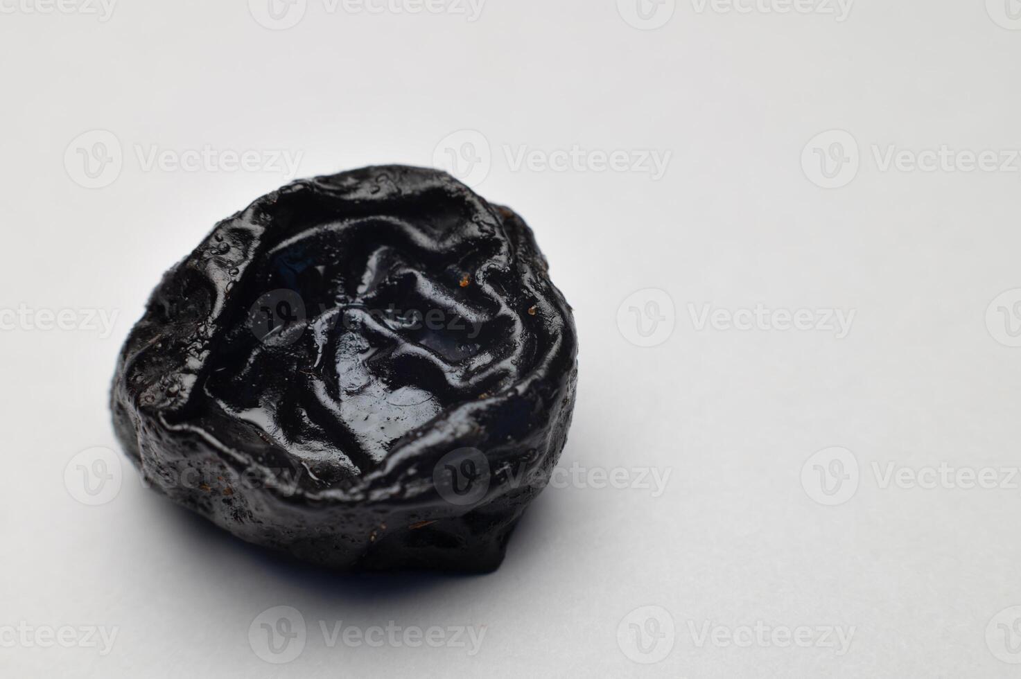Prunes on a white background close-up. Dried plum fruit photo