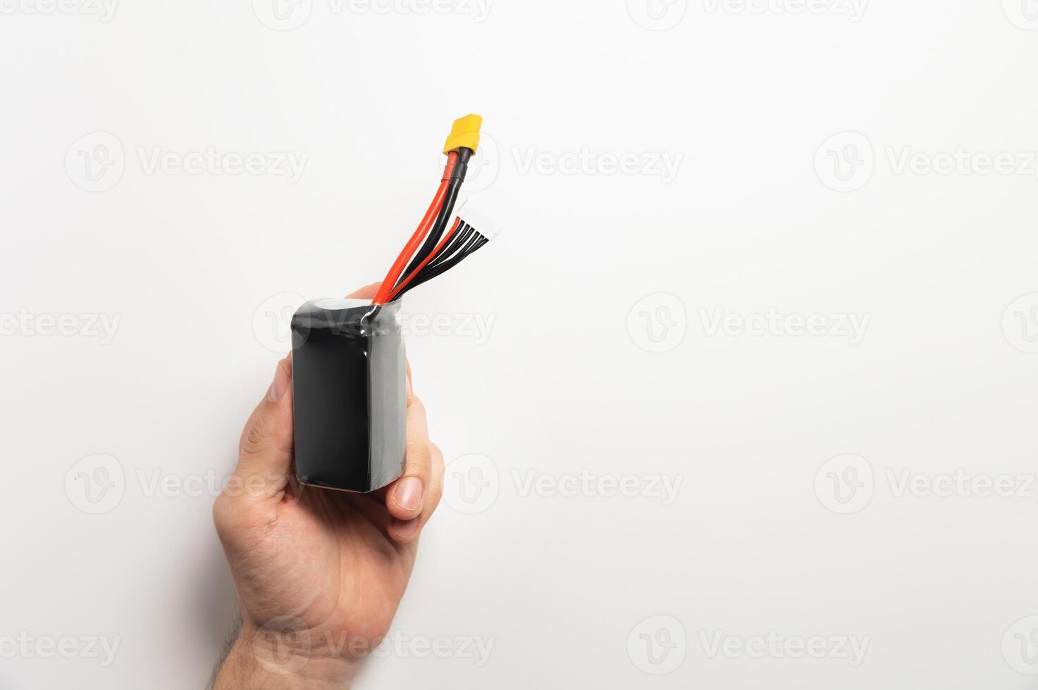 Lithium polymer battery with balancing and power connectors for powering fpv drones in a man's hand photo