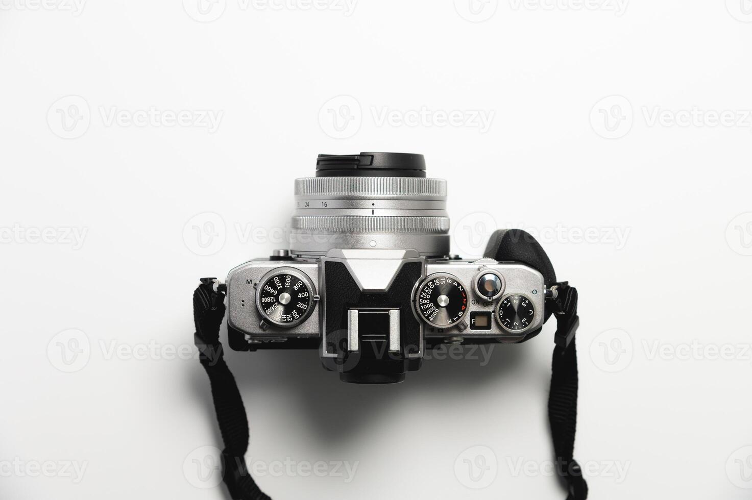 modern camera in retro style with a strap close-up, top view photo