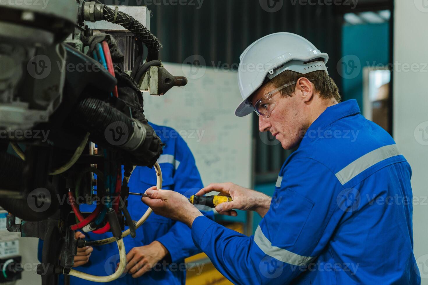 Teamwork of male engineers checking and maintaining the quality of the robot arm, robot arm factory Technology and engineering concepts. photo