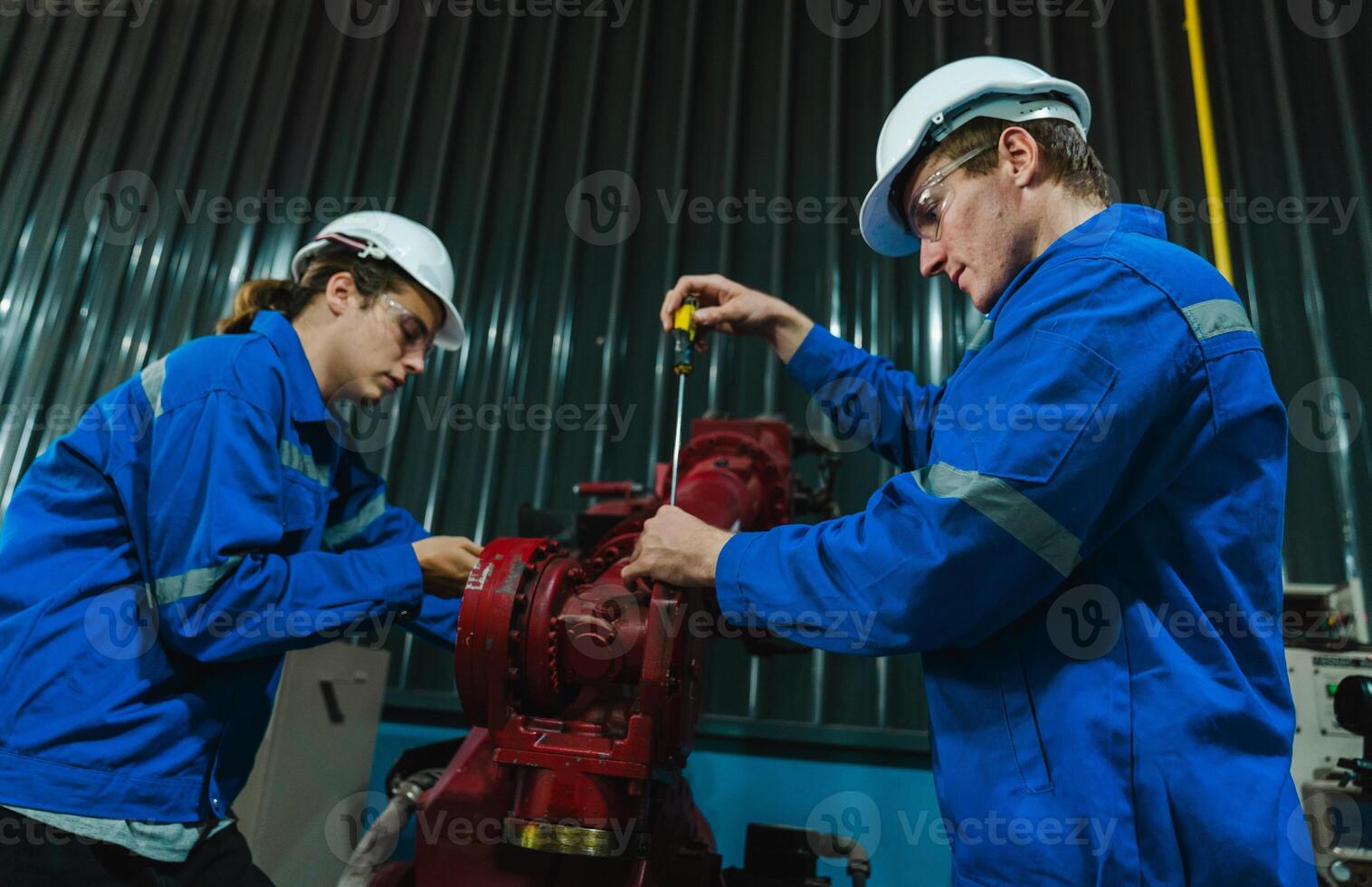 Teamwork of male engineers checking and maintaining the quality of the robot arm, robot arm factory Technology and engineering concepts. photo