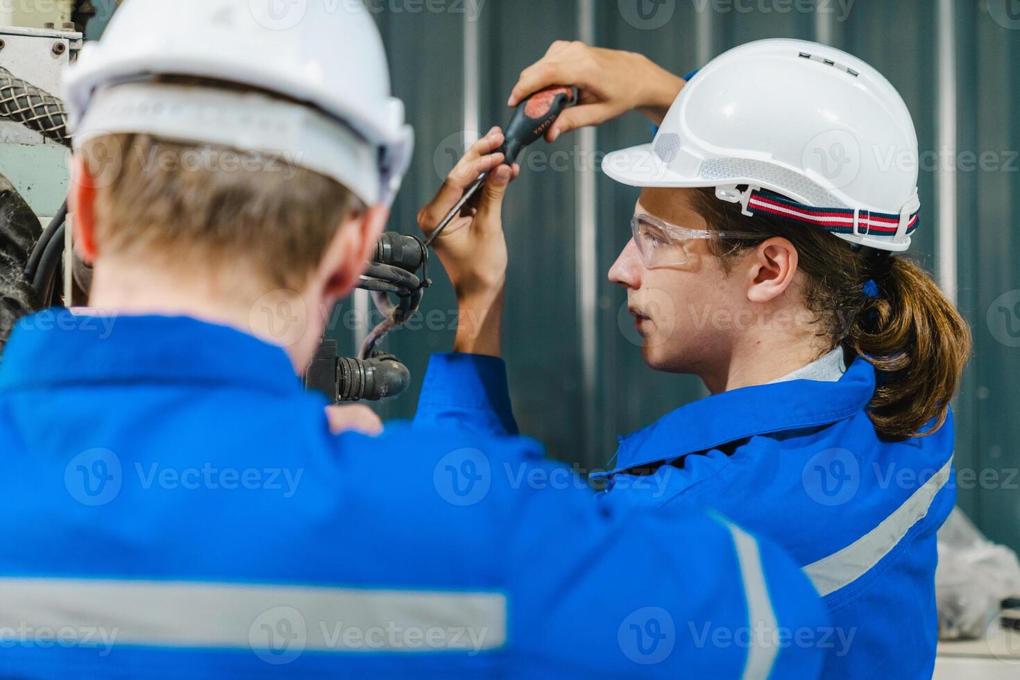 Teamwork of male engineers checking and maintaining the quality of the robot arm, robot arm factory Technology and engineering concepts. photo