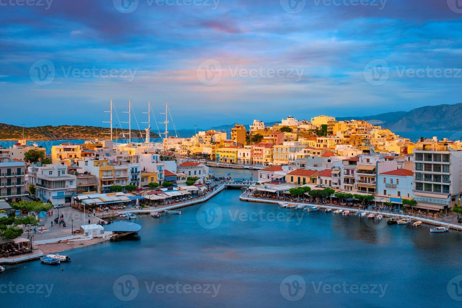 Beautiful Agios Nikolaos town on lake Voulismeni on sunset. island Crete, Greece photo