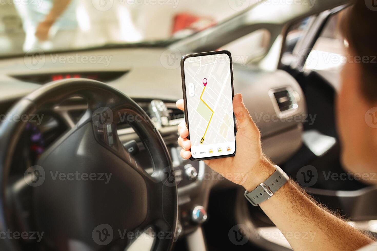 Man driver sitting in front sit in the car, holding mobile phone with map gps navigation on gadget screen, unrecognizable guy checking location destination, travelling alone by auto photo