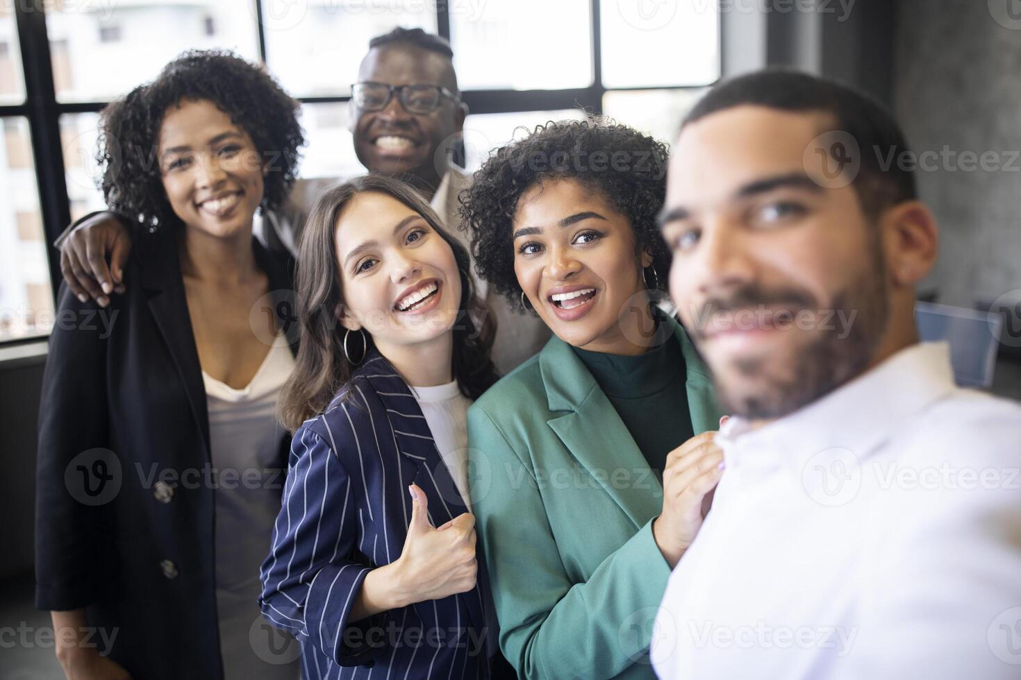 Successful Business Team. Happy Multiethnic Colleagues Businessmen And Businesswomen Making Group Selfie Smiling At Camera, Posing Together In Modern Office Indoors. Selective Focus photo