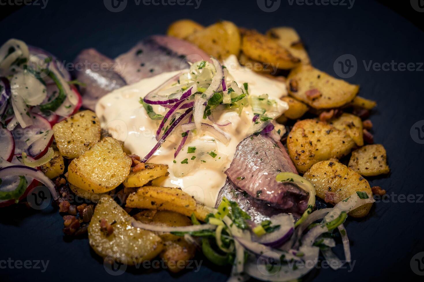 Fresh herb matjes with fried potatoes and Sylt sauce photo