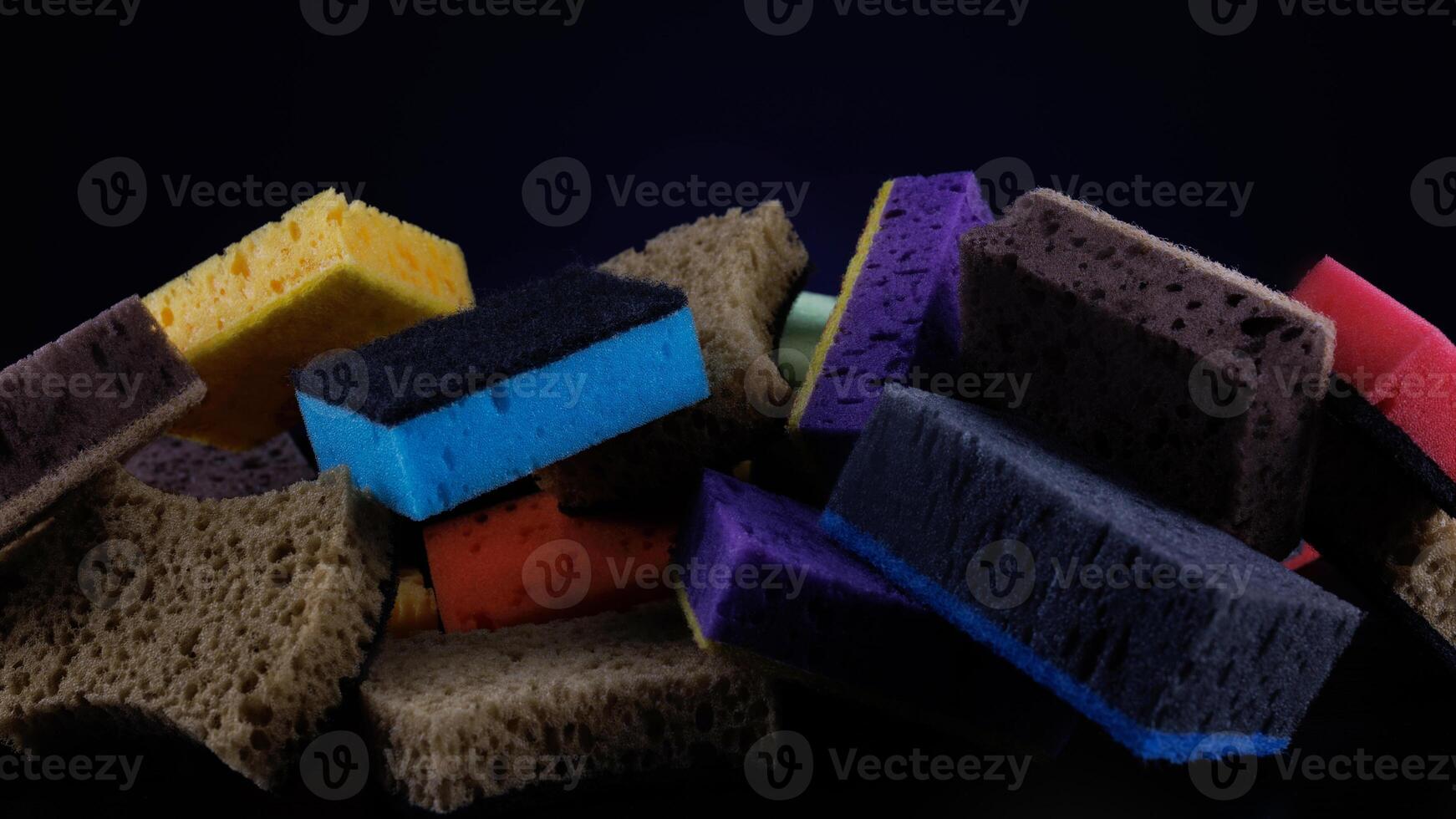 Background of mixed colorful sponges for washing dishes. Household cleaning sponge. photo