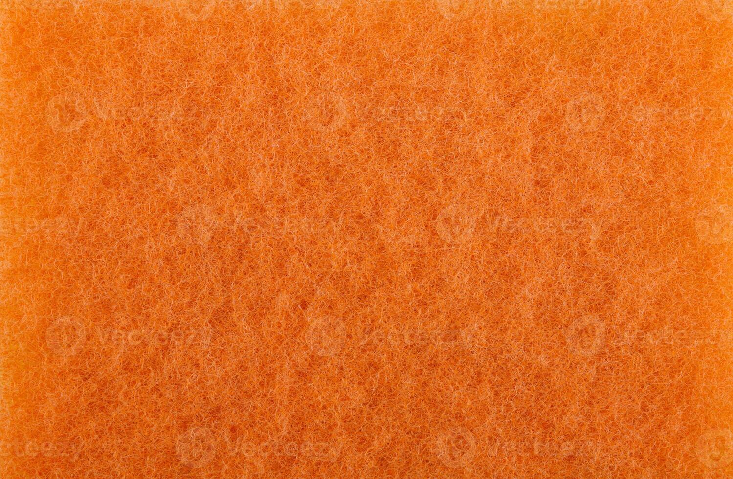 Surface of an orange cleaning sponge. Background made from orange cleaning cloth. photo
