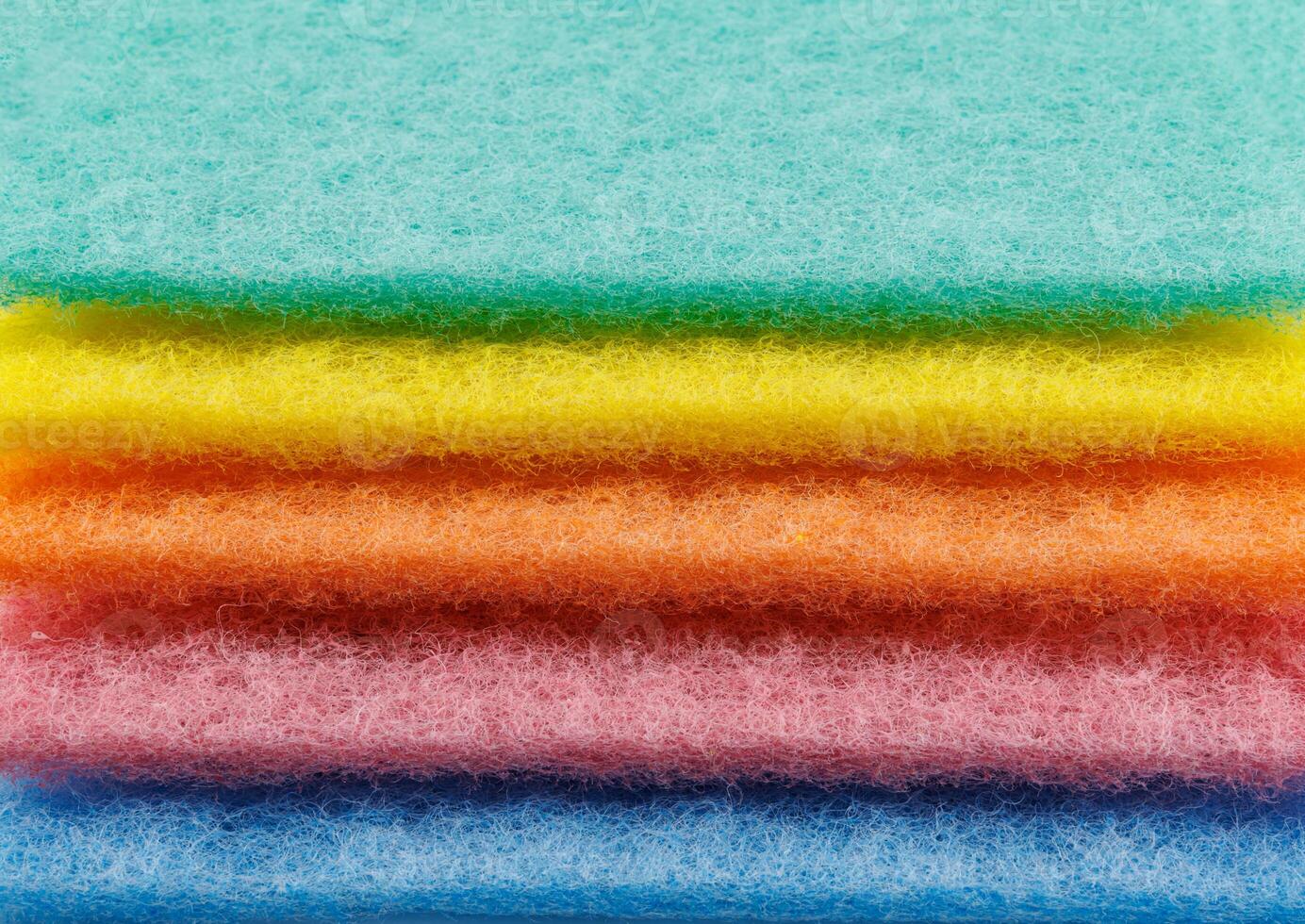 Multi-colored cleaning sponge. Background made from multi-colored cleaning cloth. photo