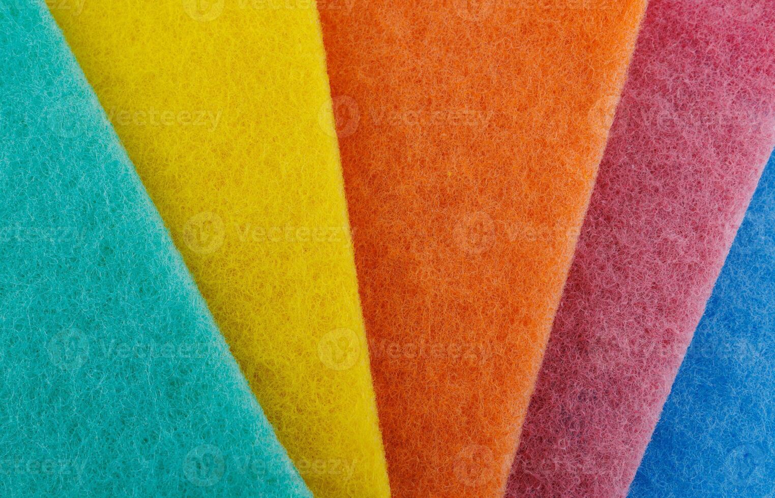 Multi-colored cleaning sponge. Background made from multi-colored cleaning cloth. photo