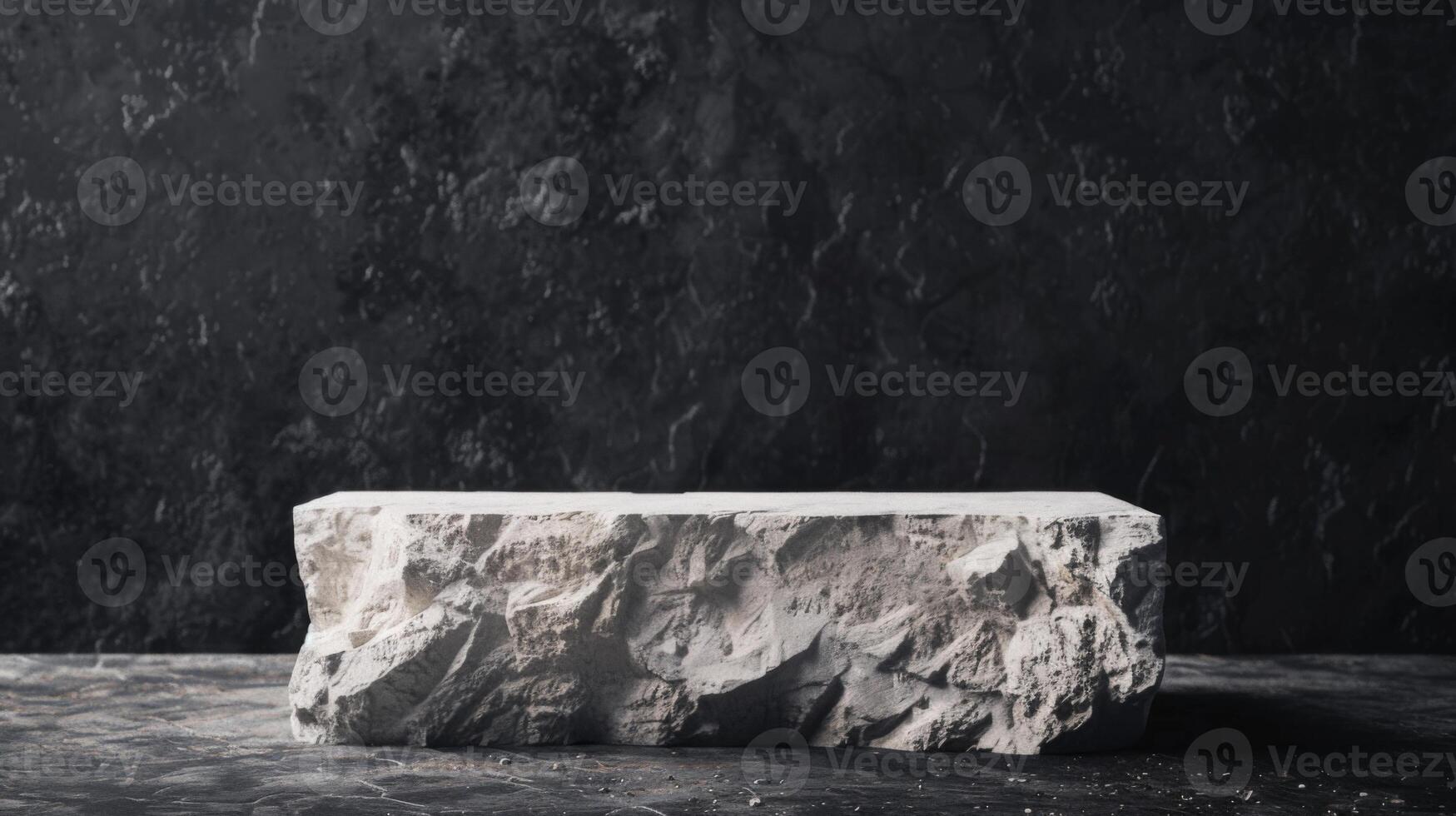 A large, rough-cut marble block rests on a dark surface with a black textured wall backdrop, lit by soft studio lighting. photo